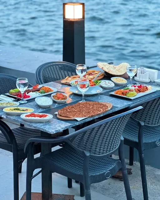 Deniz kenarında kurulmuş kebap ve meze sofrası